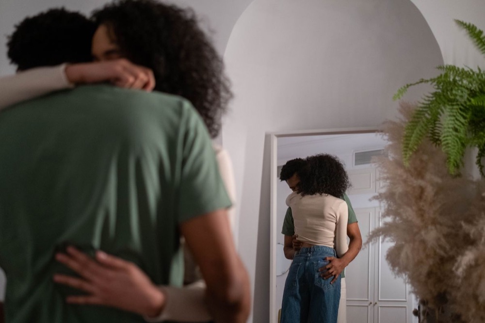 A couple holding each other at home